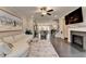 Open-concept living room featuring fireplace, hardwood floors, and a view to the kitchen at 373 Via Secco Ln, Suwanee, GA 30024