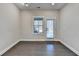 Neutral living area with hardwood floors, a bright window, and a glass door at 373 Via Secco Ln, Suwanee, GA 30024