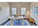 Well lit office features hardwood floors, a modern rug and two large windows at 373 Via Secco Ln, Suwanee, GA 30024