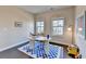Well lit office features hardwood floors, a modern rug and two large windows at 373 Via Secco Ln, Suwanee, GA 30024