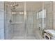 Glass enclosed shower with white tile and a window at 373 Via Secco Ln, Suwanee, GA 30024