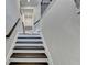 Interior view of a staircase with dark wood steps, white risers and decorative rail at 373 Via Secco Ln, Suwanee, GA 30024