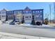 Street view shows attractive brick townhomes with well-maintained landscaping and attached garages at 373 Via Secco Ln, Suwanee, GA 30024