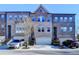Charming brick townhomes feature attached garages and a traditional architectural style at 373 Via Secco Ln, Suwanee, GA 30024