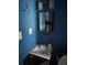 Bathroom with a sink, mirror, and blue walls at 5430 Old Bill Cook Rd, Atlanta, GA 30349