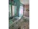 Tiled bathroom showing vanity with double mirrors, bathtub with shower curtain, and fixtures at 5430 Old Bill Cook Rd, Atlanta, GA 30349