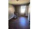 Bedroom with a window that lets in natural light and a hardwood floor in need of repair at 5430 Old Bill Cook Rd, Atlanta, GA 30349