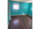 Bedroom features include hardwood floors, a window and turquoise painted walls at 5430 Old Bill Cook Rd, Atlanta, GA 30349