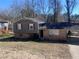 Charming split-level home with a brick facade, vinyl siding, and a covered carport at 5430 Old Bill Cook Rd, Atlanta, GA 30349