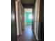 Hallway with wooden floors and multiple doors leading to various rooms, freshly painted in grey at 5430 Old Bill Cook Rd, Atlanta, GA 30349