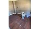 Room featuring hardwood floors, baseboards, and wall damage at 5430 Old Bill Cook Rd, Atlanta, GA 30349