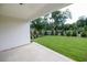 Backyard view from covered porch featuring manicured lawn and mature trees at 574 Sawnee Village Blvd, Cumming, GA 30040
