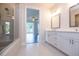 Bright bathroom featuring a walk-in shower, dual vanities, and neutral color palette at 574 Sawnee Village Blvd, Cumming, GA 30040