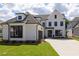 A gorgeous two-story home features a two-car garage and a meticulously kept front yard at 574 Sawnee Village Blvd, Cumming, GA 30040