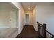 Hallway with hardwood floors and white doors leading to various rooms in the house at 574 Sawnee Village Blvd, Cumming, GA 30040