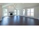 Bright living room with hardwood floors, vaulted ceiling, fireplace and large windows at 574 Sawnee Village Blvd, Cumming, GA 30040