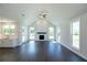 Open-plan living space with hardwood floors, fireplace, and plenty of natural light at 574 Sawnee Village Blvd, Cumming, GA 30040