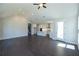 Open living room with hardwood floors and access to kitchen and staircase at 574 Sawnee Village Blvd, Cumming, GA 30040