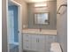 Bathroom vanity with white cabinets, marble countertop, and a framed mirror at 1546 Alverado Way, Decatur, GA 30032