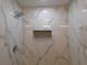 Bathroom featuring a glass shower, rainfall shower head, and marble-style tiles at 1546 Alverado Way, Decatur, GA 30032