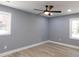 Bedroom with ceiling fan, light grey walls, and hardwood floors and natural light at 1546 Alverado Way, Decatur, GA 30032