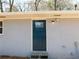 A lovely blue front door with glass panel and gray painted brickwork offers great curb appeal at 1546 Alverado Way, Decatur, GA 30032