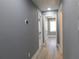 Hallway with light gray paint, wood-look flooring, and white trim at 1546 Alverado Way, Decatur, GA 30032