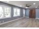 Bright living room with a ceiling fan, two large windows, and light-colored wood floors at 1546 Alverado Way, Decatur, GA 30032
