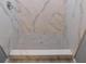 Modern tiled shower featuring marble walls and stone tile floor at 1546 Alverado Way, Decatur, GA 30032