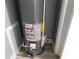 Installed water heater with warning labels, plumbing, and electrical components at 1546 Alverado Way, Decatur, GA 30032
