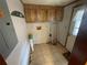 Functional laundry room with tile floor, wooden cabinets, and space for laundry appliances at 1840 Macedonia Rd, Covington, GA 30014