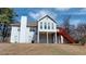 Spacious backyard view showcasing a deck with stairs, a chimney, and a partially fenced yard at 3336 Franklin Forest Dr, Winston, GA 30187