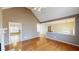 Open-concept living room with hardwood floors, a vaulted ceiling, and a seamless flow to the kitchen and dining areas at 3336 Franklin Forest Dr, Winston, GA 30187