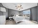 Cozy bedroom with gray walls, a ceiling fan, neutral carpet, and a large window at 4075 Winterberry Rd, Cumming, GA 30040