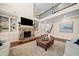 Spacious living room featuring soaring ceilings, stone fireplace and built-in bookcases at 4075 Winterberry Rd, Cumming, GA 30040