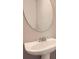 Close-up of a sleek pedestal sink and mirror at 5430 Falls Landing Dr, Cumming, GA 30040