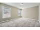 Neutral bedroom features two windows for natural light and plush carpet at 5430 Falls Landing Dr, Cumming, GA 30040