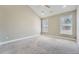 Spacious bedroom with carpeted floors and abundant natural light from multiple windows at 5430 Falls Landing Dr, Cumming, GA 30040