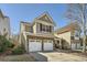 View of the property shows a two-car garage, landscaping, and neutral color scheme at 5430 Falls Landing Dr, Cumming, GA 30040