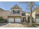 Charming two-story home with a stone-accented facade and two-car garage at 5430 Falls Landing Dr, Cumming, GA 30040