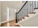 A bright entry foyer features hardwood floors and an elegant staircase at 5430 Falls Landing Dr, Cumming, GA 30040
