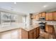 Well-lit kitchen with hardwood floors, granite island, and stainless steel appliances at 5430 Falls Landing Dr, Cumming, GA 30040