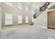 Spacious living room featuring natural light, high ceilings and staircase at 5430 Falls Landing Dr, Cumming, GA 30040