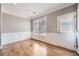 Cozy living room featuring wainscoting, window and door for natural light and access at 5430 Falls Landing Dr, Cumming, GA 30040