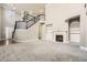 Open-concept living room with fireplace, staircase and great natural light at 5430 Falls Landing Dr, Cumming, GA 30040