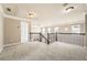 A spacious loft with wrought iron railing, carpet, and an open layout at 5430 Falls Landing Dr, Cumming, GA 30040