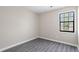 Bright bedroom featuring modern gray vinyl floors and one windows for natural light at 801 Hemingway Rd, Stone Mountain, GA 30088