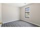 Neutral bedroom with gray floors and a window, offering a minimalist design at 801 Hemingway Rd, Stone Mountain, GA 30088