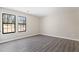 Bright bedroom featuring modern gray vinyl floors and two windows for natural light at 801 Hemingway Rd, Stone Mountain, GA 30088