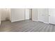 Spacious bedroom showcasing sleek gray floors and a series of closet doors at 801 Hemingway Rd, Stone Mountain, GA 30088